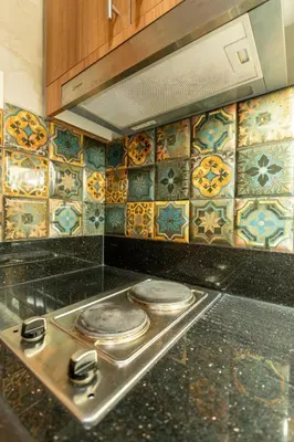 a kitchen with two plates on a counter with tiles at Modern Industrial 1 BR | Condo | MOA Shore 3 NAIA in Manila