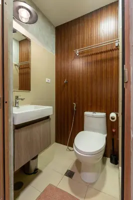 a bathroom with a toilet and a sink at Modern Industrial 1 BR | Condo | MOA Shore 3 NAIA in Manila