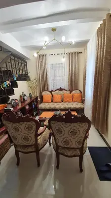 a living room with a couch and two chairs at David home in Manila
