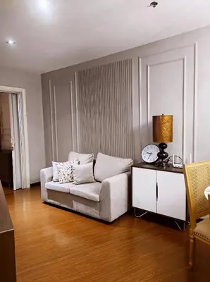 a living room with a couch and a table at Elegant Stylish 1 Bedroom Balcony City and Manila Bay view FREE Sauna Pool GYM Makati in Manila