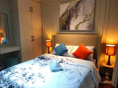 a bedroom with a bed with a tray on it at Elegant Stylish 1 Bedroom Balcony City and Manila Bay view FREE Sauna Pool GYM Makati in Manila