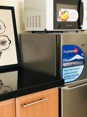 a kitchen with two refrigerators and a box of food at Grand view Venice 1BR with balcony near BGC in Manila