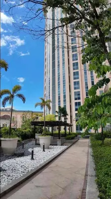 a walkway in front of a tall building at Grand view Venice 1BR with balcony near BGC in Manila