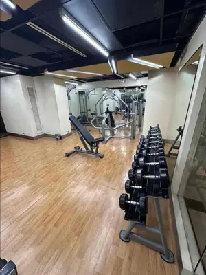 a gym with rows of dumbbells in a gym at Grand view Venice 1BR with balcony near BGC in Manila