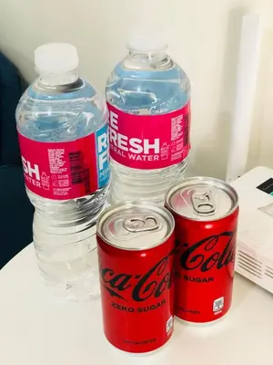 a group of three bottles of water sitting on a table at Haven in Manila Venice 1BR with balcony near BGC in Manila