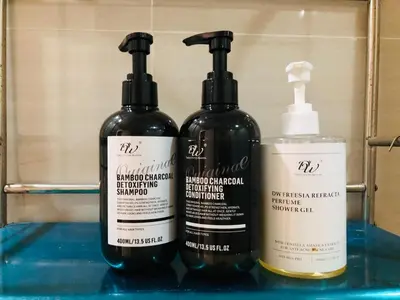 a group of three bottles sitting on a shelf at Haven in Manila Venice 1BR with balcony near BGC in Manila