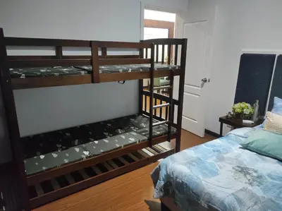 a room with a bunk bed and a room with a bed at Big NEW 1 Bedroom corner unit with Balconies - FREE Sauna Pool Gym View of Skyline, Manila Bay, Sunset in Manila