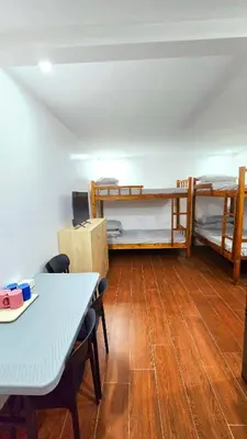 a room with two bunk beds and a table at Studio Units near Airport by Jade Studio Apartments in Manila