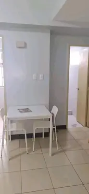 a white table and two chairs in a room at Staycation at CJS in Manila