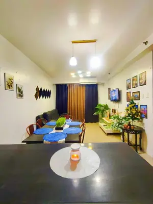 a living room with a table and a couch at Bahay Pahuway in Manila