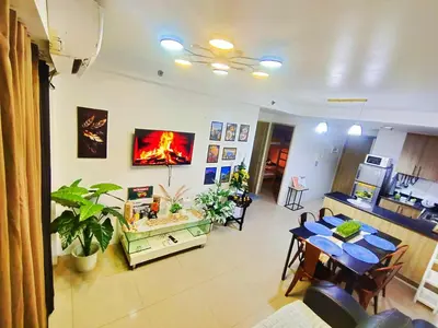 a living room with a table and a dining room at Bahay Pahuway in Manila