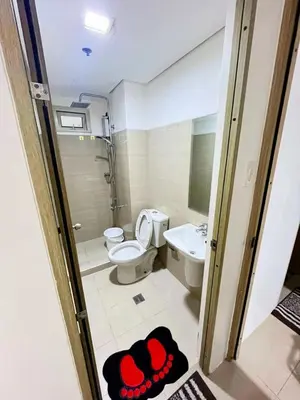 a bathroom with a toilet and a sink at Bahay Pahuway in Manila