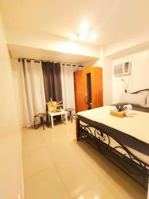 a bedroom with a large bed in a room at Bahay Pahuway in Manila