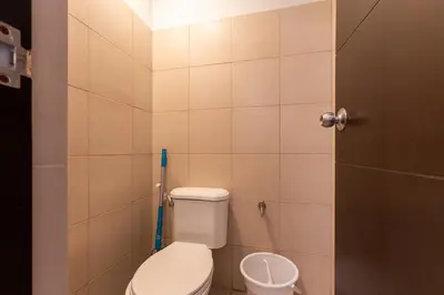 a small bathroom with a toilet and a sink at Spacious 3 BR in Uptown Parksuites, BGC Fast Wi Fi Washer in Manila