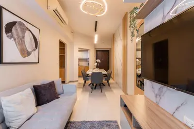 a living room with a couch and a tv at Spacious 3 BR in Uptown Parksuites, BGC Fast Wi Fi Washer in Manila