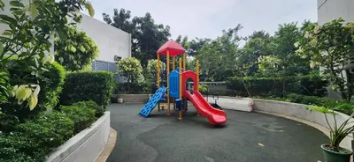 a playground with a slide in a garden at 22e BGC Unit 3 mins Walk to The Venice Grand Canal Mall Pet Friendly in Manila