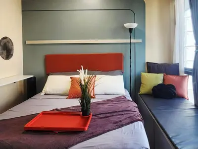 a bedroom with a bed with a red tray on it at 22e BGC Unit 3 mins Walk to The Venice Grand Canal Mall Pet Friendly in Manila