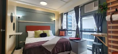 a bedroom with a bed and a large window at 22e BGC Unit 3 mins Walk to The Venice Grand Canal Mall Pet Friendly in Manila