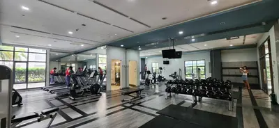 a gym with treadmills and people exercising in it at 22e BGC Unit 3 mins Walk to The Venice Grand Canal Mall Pet Friendly in Manila