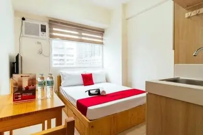 a small room with a bed in a kitchen at Urban Deca Tower Jen Nizami in Manila
