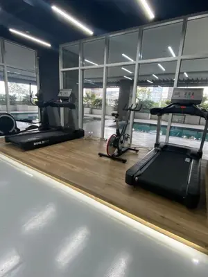 a gym with two treadmills and two exercise bikes at EDSA Heights Penthouse unit 3402 AMA Tower Residences in Manila