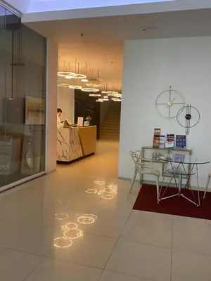 a lobby with a table and a desk in a building at EDSA Heights Penthouse unit 3402 AMA Tower Residences in Manila