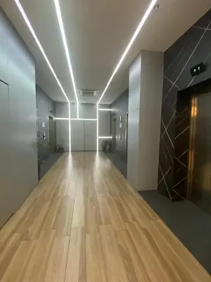 an empty hallway with wooden floors in a building at EDSA Heights Penthouse unit 3402 AMA Tower Residences in Manila