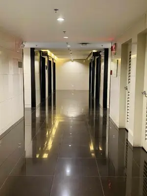 an empty hallway in a building with a tile floor at Air Residences 46F Stunning View Wifi & Netflix in Manila
