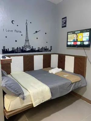 a bedroom with a bed with a sign that says i love paris at Airport Transient Pasay in Manila
