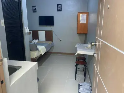 a small room with a bed and a bathroom at Airport Transient Pasay in Manila