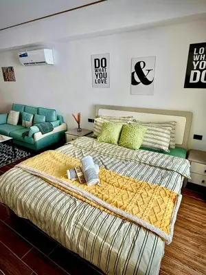a bedroom with a large bed and a couch at Sy bay suites beside okada manila near MOA COD T3 MSV2117H in Manila