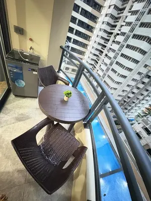 a table and chairs on top of a building at Sy bay suites beside okada manila near MOA COD T3 MSV2117H in Manila