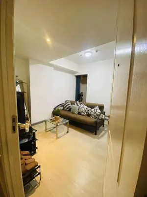 a living room with a couch and a table at Azure Urban Staycation in Manila