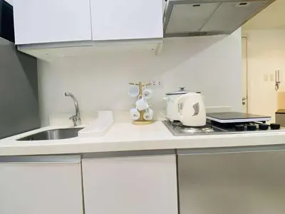 a kitchen with a sink and a counter top at Azure Urban Staycation in Manila