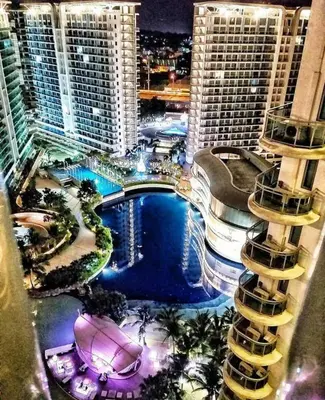 an aerial view of a resort with a pool and buildings at Azure Urban Staycation in Manila