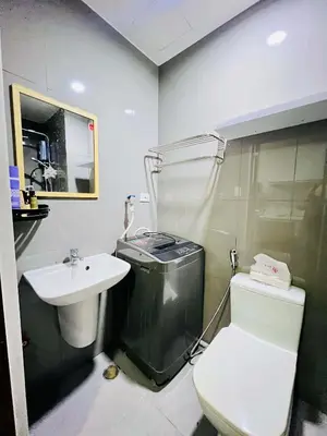 a bathroom with a toilet and a sink at Air residence city view staycation in Manila