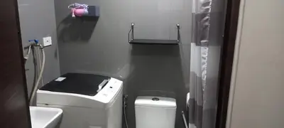 a small bathroom with a toilet and a sink at Air residence city view staycation in Manila