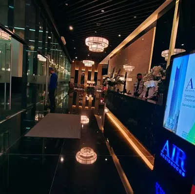 a lobby of a building with a bar and a tv at Air residence city view staycation in Manila