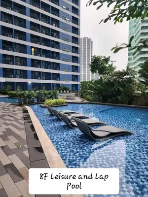 a swimming pool in a city with a building at Air residence city view staycation in Manila