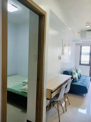 a room with a table and a bed and a mirror at Seren View Bedspace - S Residences in Manila