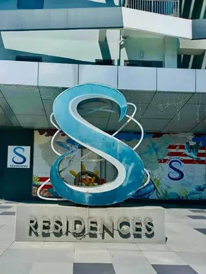 a sign with the number six in front of a building at Seren View Bedspace - S Residences in Manila