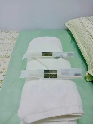 a pile of towels sitting on top of a bed at Seren View Bedspace - S Residences in Manila