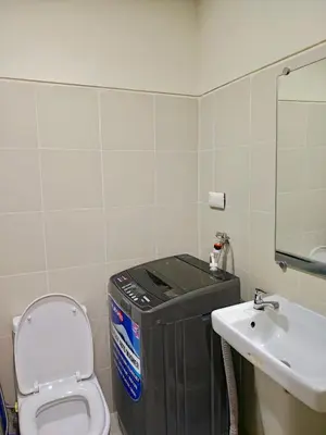 a small bathroom with a toilet and a sink at Seren View Bedspace - S Residences in Manila