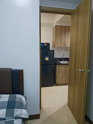 an open door to a kitchen with a refrigerator at Seren View Bedspace - S Residences in Manila