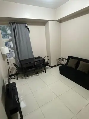 a living room with a couch and a table at 101 Newport Boulevard Pasay City Condotel in Manila