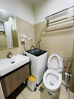 a bathroom with a white toilet and a sink at MOA GRAND STAY Suite08 Newly Turn-over Only! in Manila