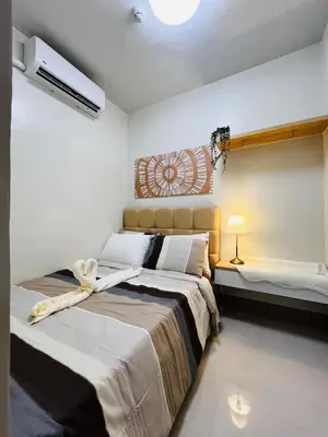a bedroom with two beds and a air conditioner at MOA GRAND STAY Suite08 Newly Turn-over Only! in Manila