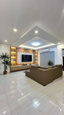 a living room with a couch and a flat screen tv at 4 Bedroom House for 5-6 guests in Manila
