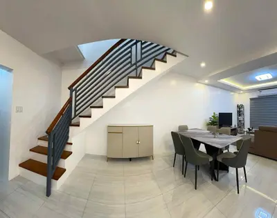 a dining room with a table and a staircase at 4 Bedroom House for 5-6 guests in Manila