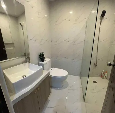 a bathroom with a toilet and a sink and a shower at 4 Bedroom House for 5-6 guests in Manila